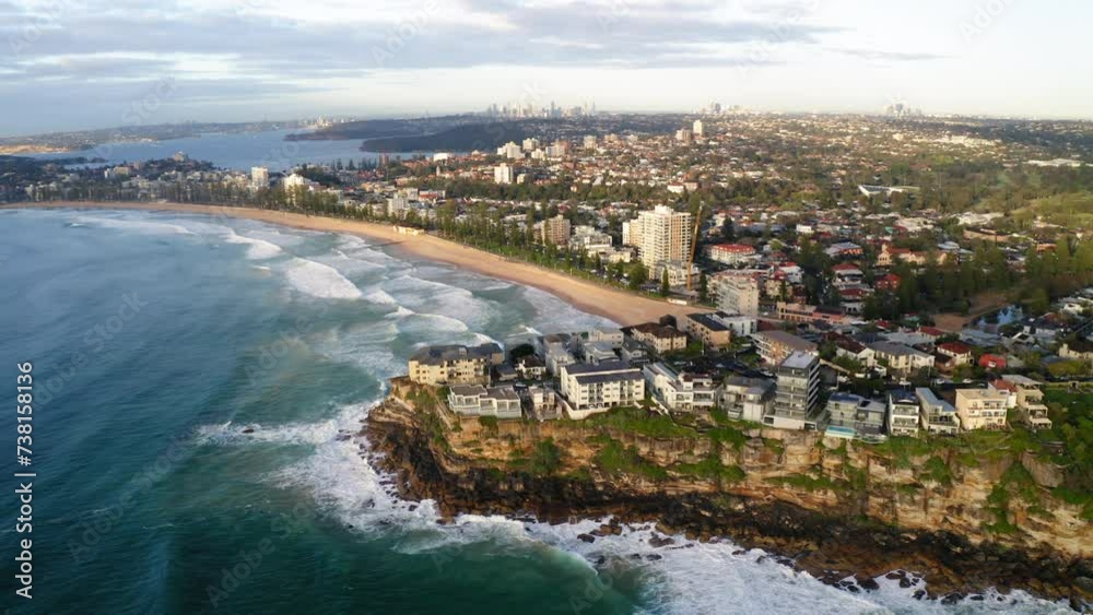 Aerial Scenic View Of Residential Buildings On Cliff At Beach, Drone Flying Backwards Over Wavy Sea - Manly, Australia Aerial Scenic View Of Residential Buildings On Cliff At Beach, Drone Flying Backwards Over Wavy Sea - Manly, Australia