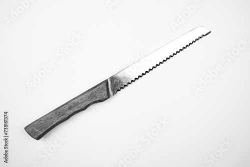 Knife with a wooden handle on an isolated background. The knife is serrated.