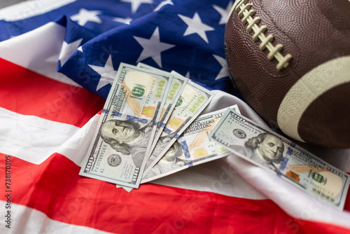 Money and rugby ball on american flag background, closeup. Concept of sports bet photo