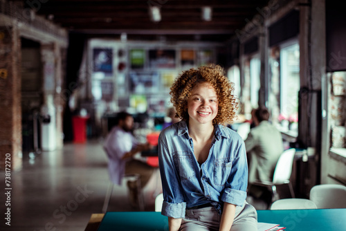 Young caucasian woman in a startup company office portrait