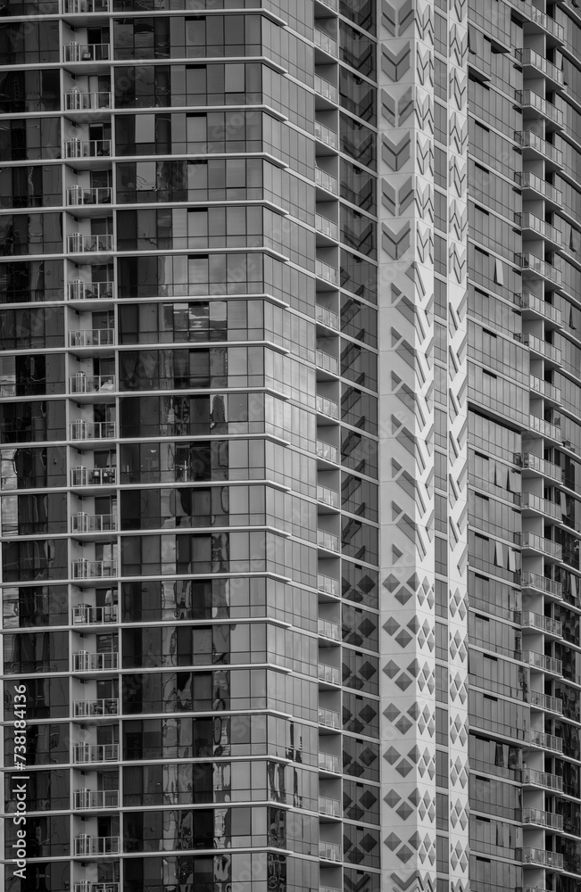 Corner View of a Building with Window Reflections in Black and White. Corner View of a Building with Window Reflections in Black and White.