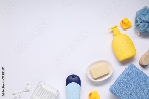 Different baby bath accessories and cosmetic products on white background, flat lay. Space for text