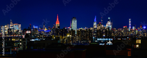 New York City Night Skyline, Skyscrapers, and Reflections, a vibrant beautiful aerial panoramic view from Brooklyn of the iconic metropolis of America © Naya Na