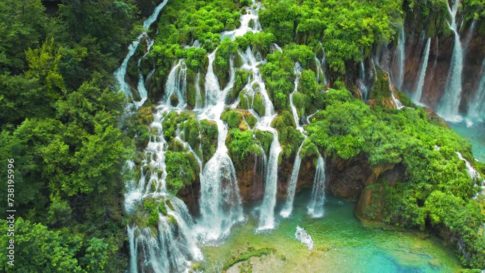 Tropical forest and mountain landscape with streams of water and waterfalls. Cascades flow among lush greenery in spring or summer.