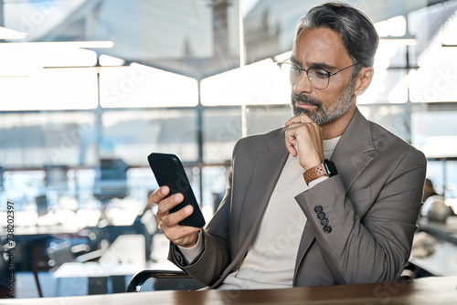 Fotografi Busy mature business man investor thinking looking at mobile cell phone in office