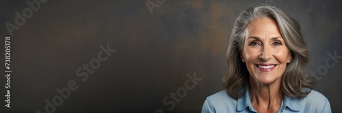 Portrait of an elderly woman on a gray background © POLEX