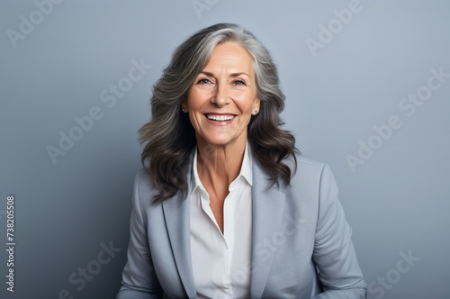 Portrait of an elderly woman on a gray background