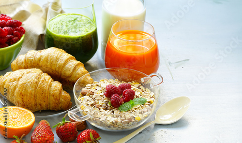assortment breakfast croissants and muesli juices and berries
