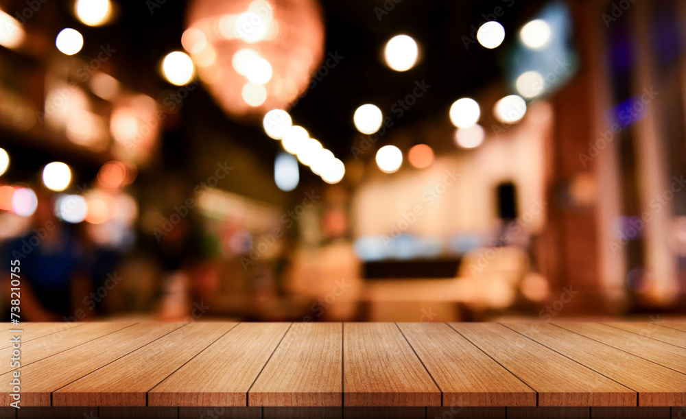 Empty wooden table top with lights bokeh on blur restaurant background. Empty wooden table top with lights bokeh on blur restaurant background.