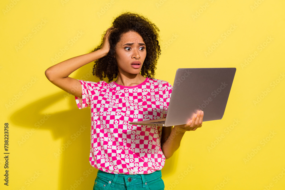Photo of impressed worried lady arm touch head stare laptop screen isolated on yellow color background Photo of impressed worried lady arm touch head stare laptop screen isolated on yellow color background