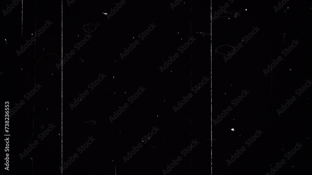 Overlay of black background with screen with scratches and white dots from dust