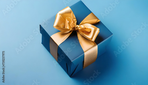 Stylish Blue Gift Box with a Golden Bow on a Blue Background for Father's Day with copyspace © PhotoStorm_22