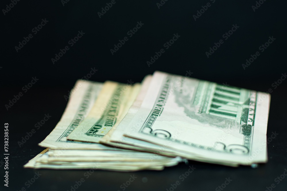 A pile of money including five dollar bills and twenty dollar bills. A pile of money including five dollar bills and twenty dollar bills.