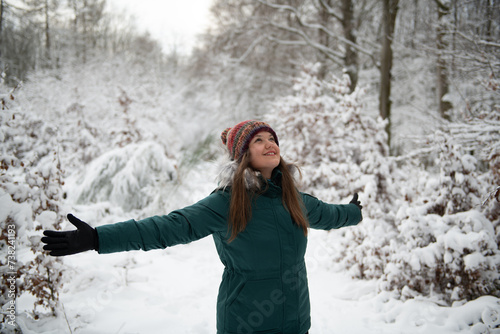 Joyful Woman in Snowy Forest Landscape