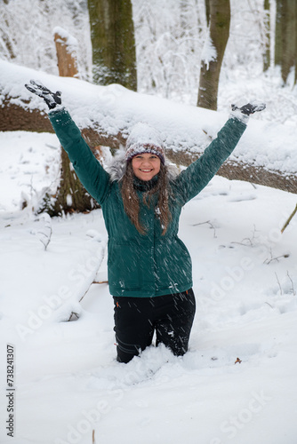 Elation in the Snow: Woman with Raised Arms in Winter Forest