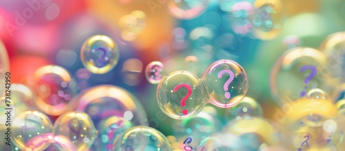 Many questions in bubbles, surrounded by question marks. photo