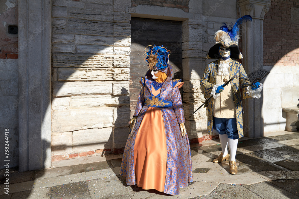 Obraz premium Venice, Italy - February 2024 - carnival masks are photographed with tourists in San Marco square