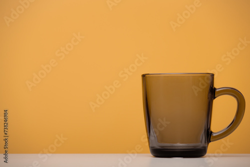 Glass mug mockup, close-up, yellow background.