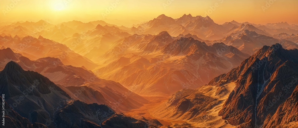 Warm sunset light bathing a rugged mountain range in a high-resolution panoramic view.