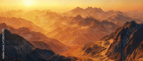 Warm sunset light bathing a rugged mountain range in a high-resolution panoramic view.