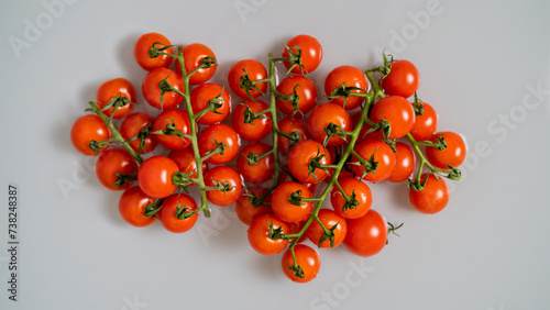 Red cherry tomatoes on a branch, washed with water. Top view.