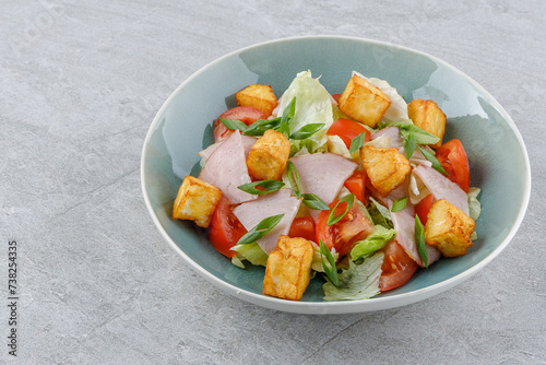 salad with ham and halloumi cheese on a stone background studio food photo 1