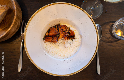 Dark roasted butter pumpkin with whipped creamy sauce make with Ossau-Iraty sheep cheese from Basque County France served in French restaurant in Bordeaux region photo