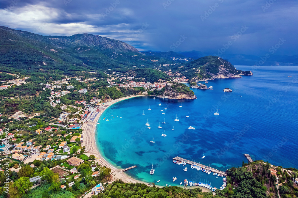 Aerial view (drone) of Valtos beach with picturesque Parga town (and its castle) in the background. Preveza prefecture, Epirus, Greece