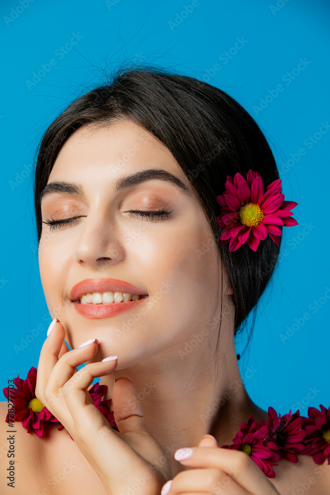 Portrait of elegant, happy model having photoshoot indoors, posing with flowers in hair, raising hands. Concept of beauty. Portrait of elegant, happy model having photoshoot indoors, posing with flowers in hair, raising hands. Concept of beauty.