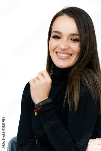 Young woman is sitting in chair and smiling