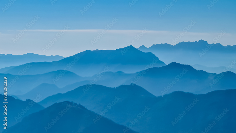 Panoramic view of magical mountain peaks of Karawanks and Julian Alps seen from Goldeck, Latschur group, Gailtal Alps, Carinthia, Austria, EU. Mystical atmosphere in Austrian Alps on sunny summer day.