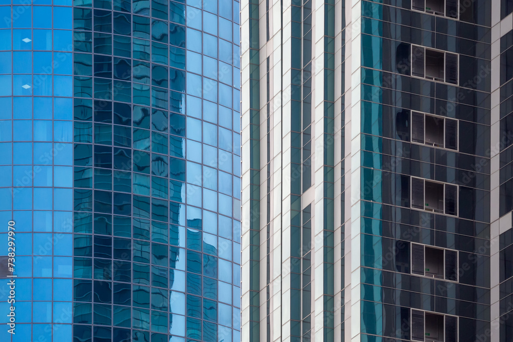 Obraz premium Fragment of business district, glazing of tall buildings for architectural backgrounds. Perfect for illustrating urban landscapes, modern architecture, and corporate environments