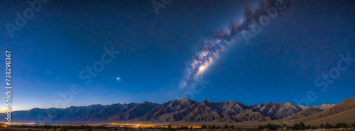 Panoramic view of the night sky and the moon over the mountains photo