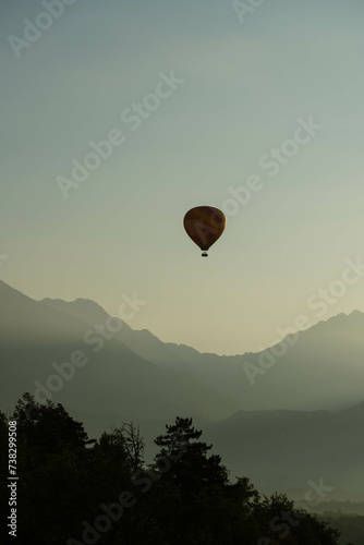 hot air balloon in flight over beautiful clear morning sky © Radu
