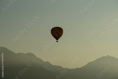 hot air balloon in flight over beautiful clear morning sky