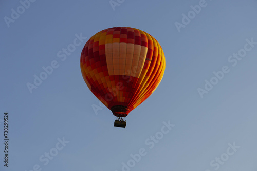 hot air balloon in flight over beautiful clear morning sky photo