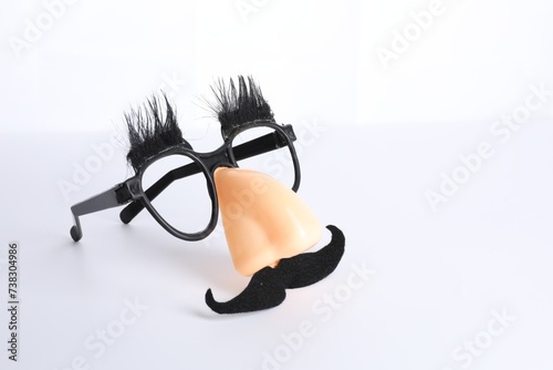 Funny mask with fake mustache, nose and glasses isolated on white