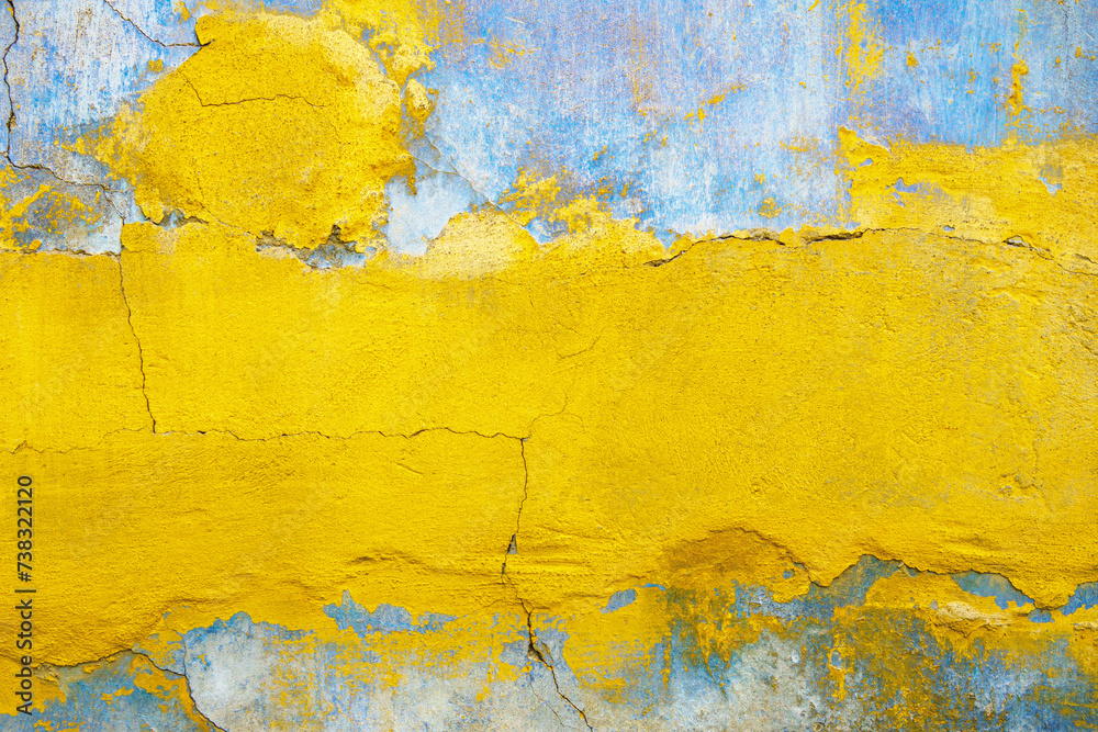 Yellow blue cracked faded stucco background