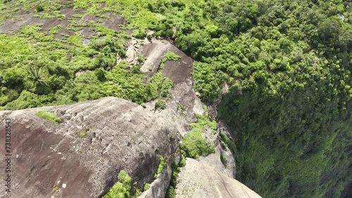 Aerial shot drone descends next to monolith  with camera pointing down giving a vertigo effect photo