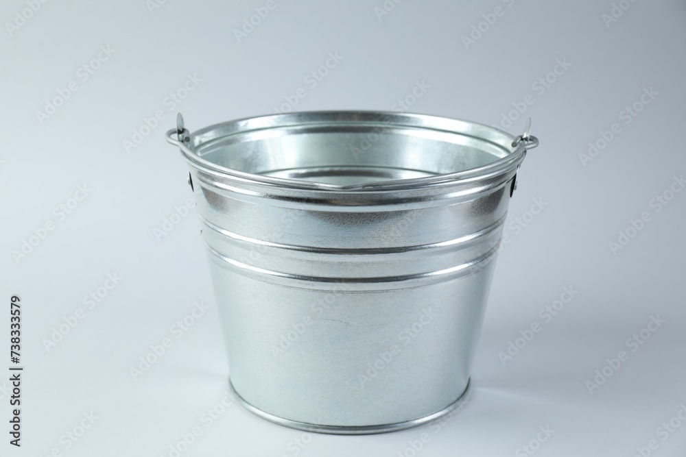 One shiny metal bucket on white background One shiny metal bucket on white background