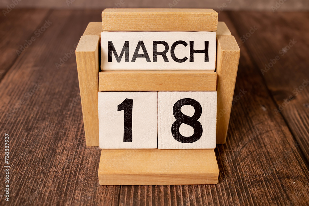 March 18 calendar date text on wooden blocks with blurred park background. Copy space and calendar concept. March 18 calendar date text on wooden blocks with blurred park background. Copy space and calendar concept.