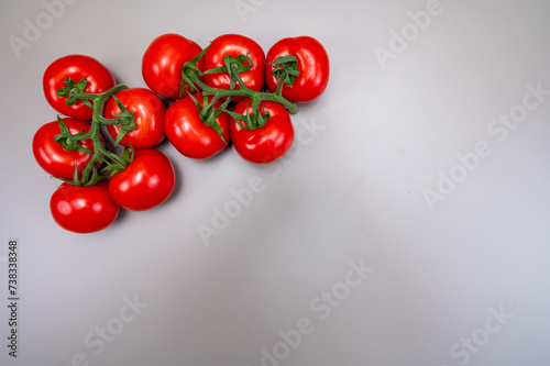 Red ripe tasty Dutch tomatoes growing indoor in greenhouse all seasons, food industry in Netherlands close up copy space © barmalini