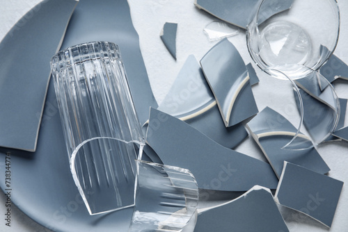 Broken glasses and plate on light background, closeup