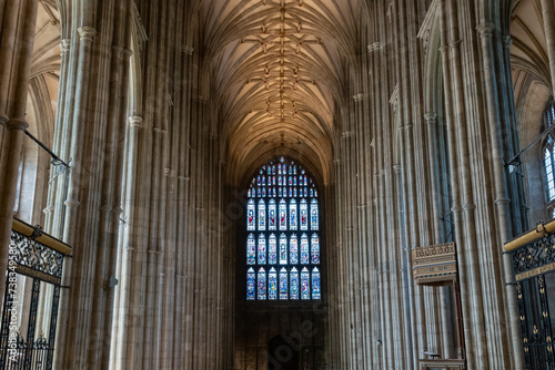 Stunning Gothic arches on ceiling of nave with a stained glass window at the end