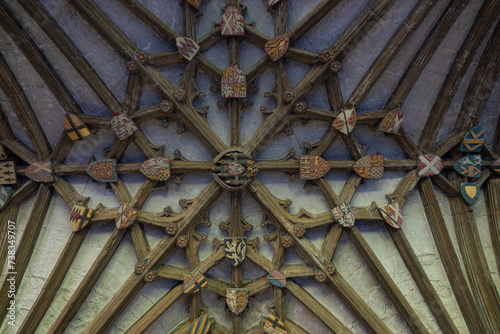 Symmetrical intertwining of rib vaults on the ceiling with heraldic symbols