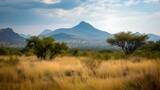 Serenity in nature: a picturesque african savannah landscape with lush trees and mountain backdrop. ideal for wall art and background use. AI