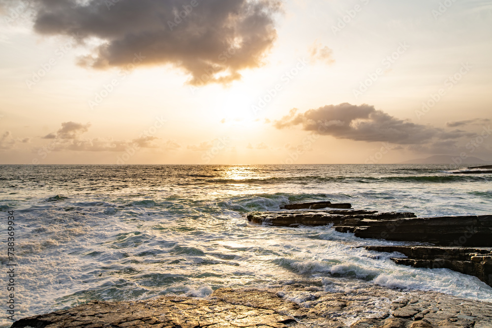 Sunset view of Mullaghmore Head with huge waves rolling ashore. Picturesque scenery with rocky coastline in evening light. Signature point of the Wild Atlantic Way, County Sligo, Ireland