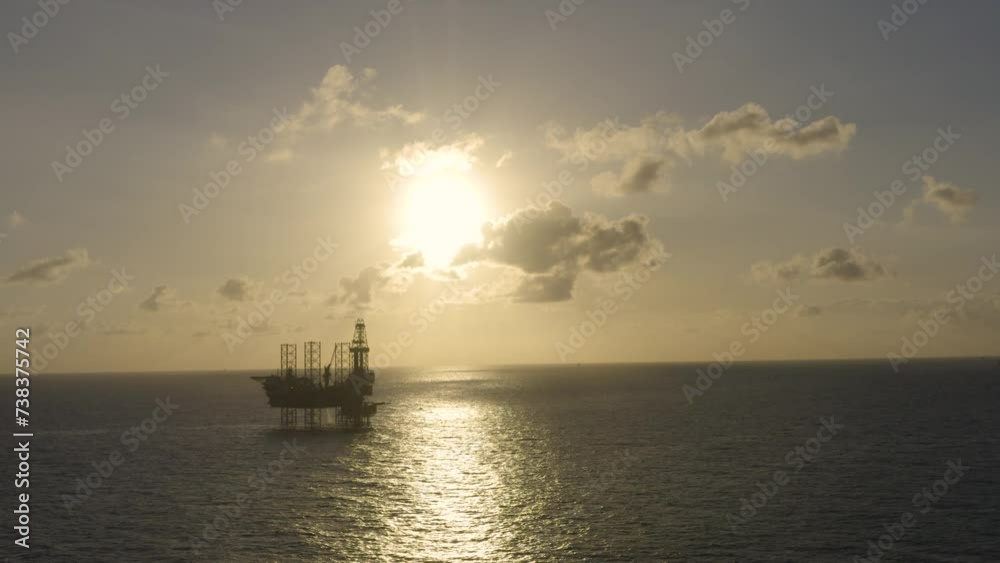 Aerial view of silhouette offshore jack up drilling rig during sunset - oil and gas industry
Aerial view of silhouette offshore jack up drilling rig during sunset - oil and gas industry