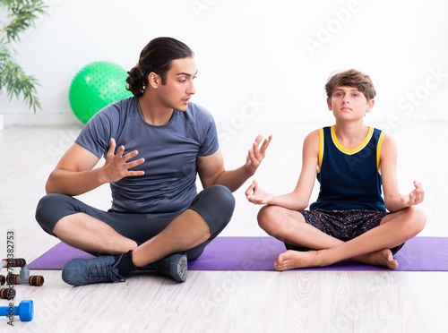 Young father and his son doing exercises