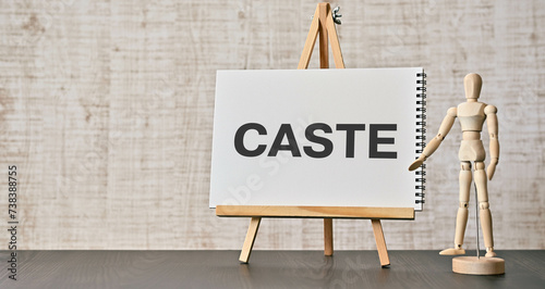 There is notebook with the word CASTE. It is as an eye-catching image. photo
